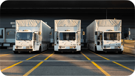 Thumbnail of Three large trucks lined up in a row (Opens About us video in modal window)
