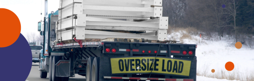 Flatbed trailer transporting an oversized load secured with chains.