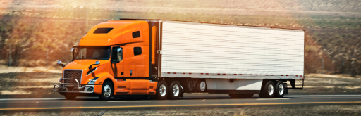 Orange truck transporting cross border full truckload freight