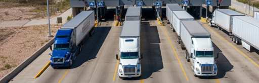 Semi-trucks crossing a border checkpoint, representing First Frontier Logistics' expertise in cross-border freight between Canada, USA, and Mexico.