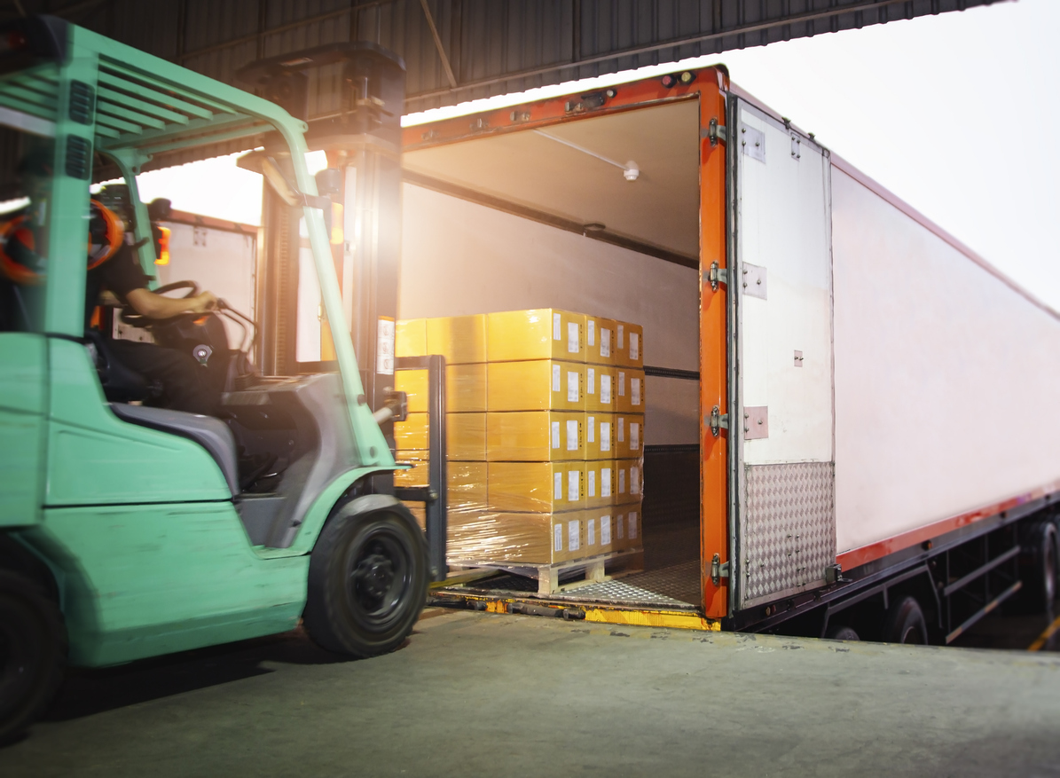 Forklift loading dedicated freight onto a truck for time-sensitive shipping